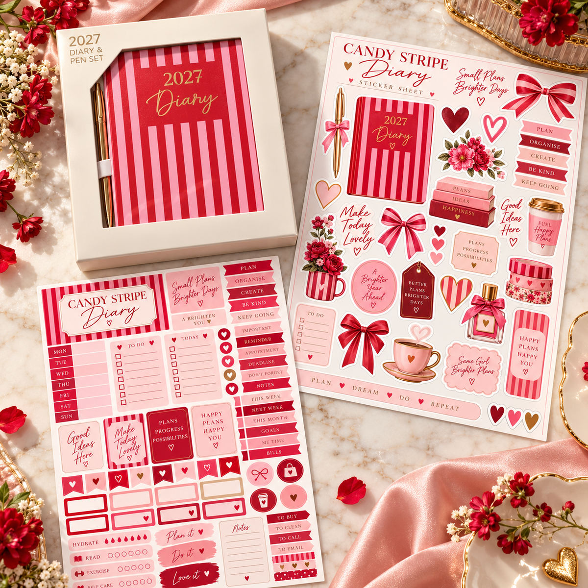 Candy Stripe 2027 mini diary and gold pen boxed with two red and pink sticker sheets on a marble desk