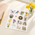 Spring garden watercolour sticker sheet styled on a cream desk with a notebook, gold pen and daffodils.